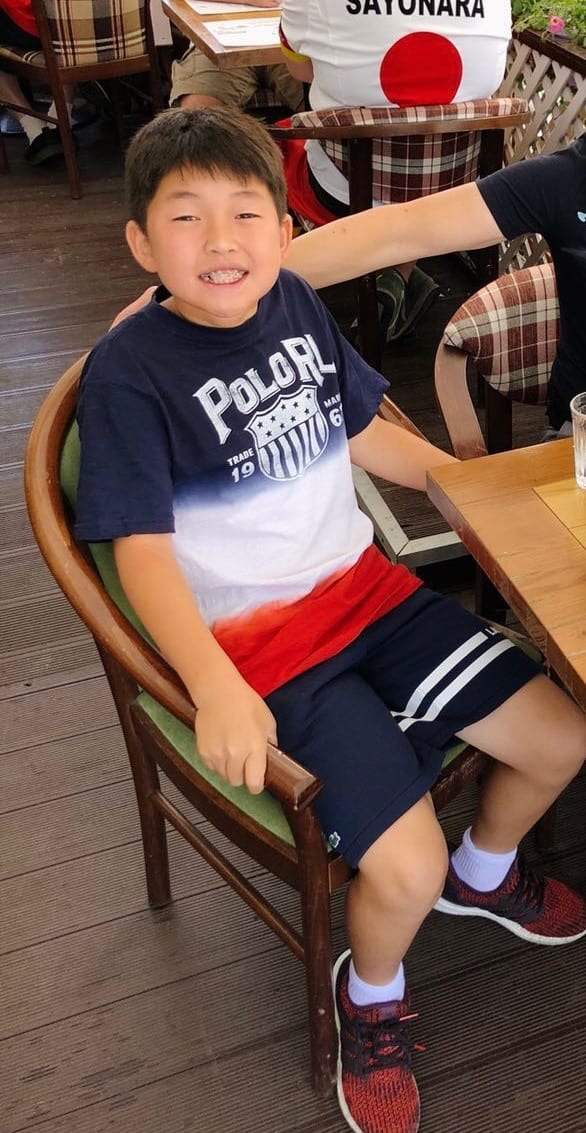 Jonathan Wang as a child sitting at a table during the Russia World Cup in 2018