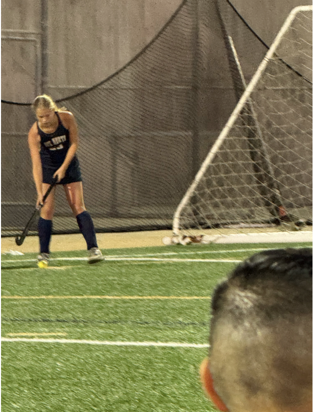 Carey Zaletski playing field hockey on a turf field