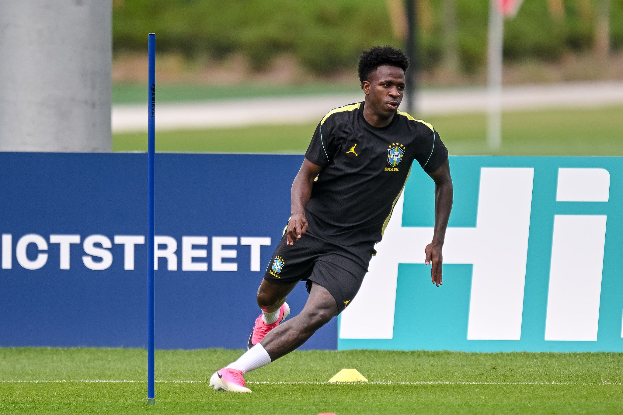 Vinícius Júnior training with the Brazil national football team on a grass pitch.